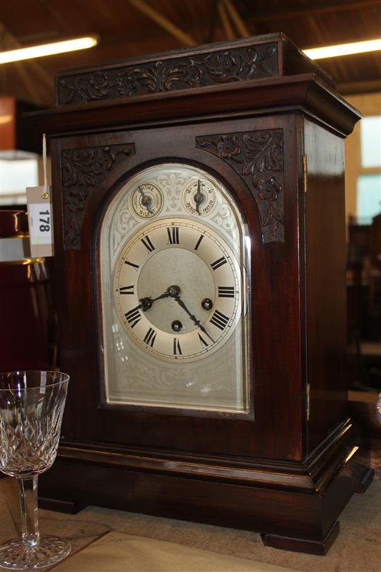 An early 20th century carved walnut mantel clock, 17in.